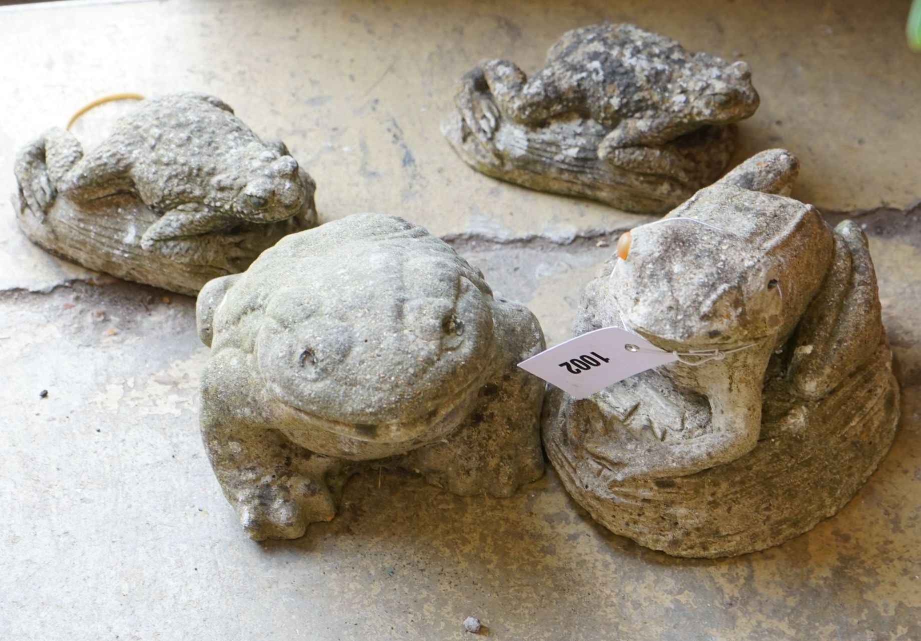 Four reconstituted stone frog garden ornaments, largest height 15cm